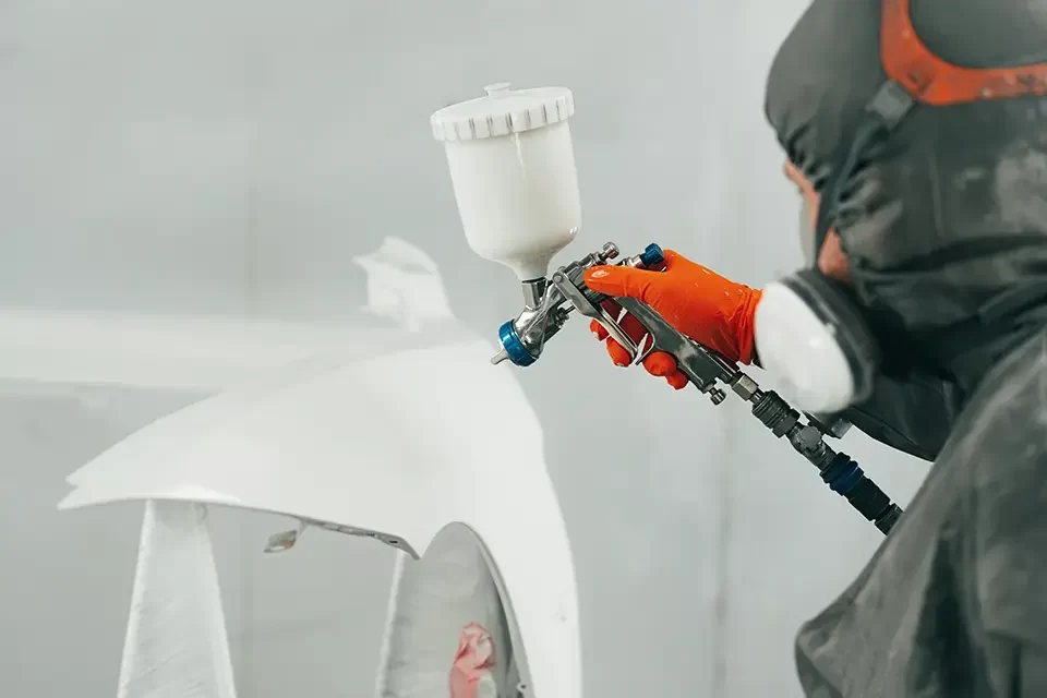 auto-painter-painting-a-car-with-vaporizer-gun- What Makes a BMW Auto Body Shop Stand Out?