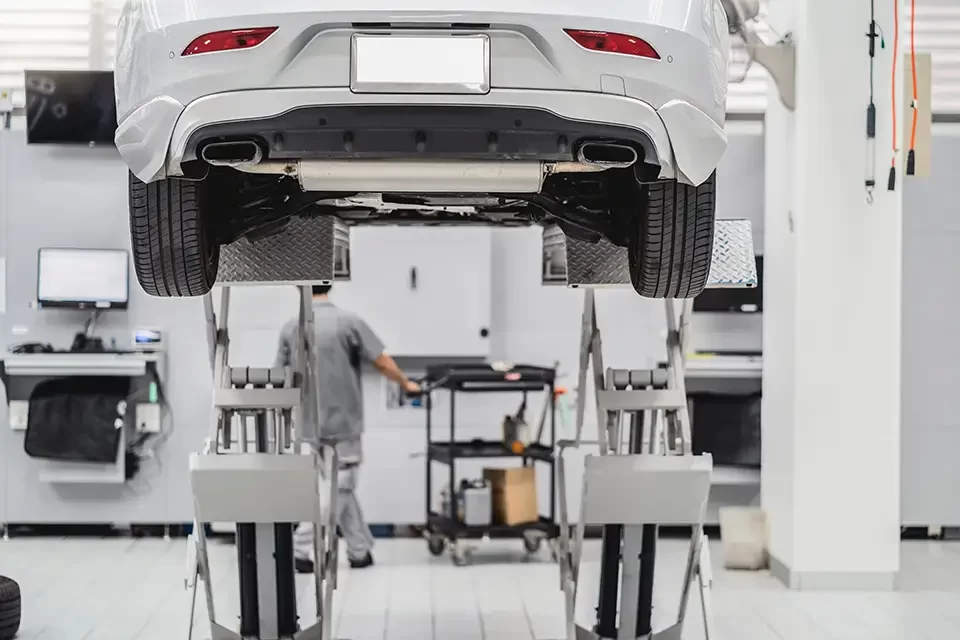 back-side-of-car-lifted-in-automobile-service What Services Should Muffler Shops in My Area Offer?