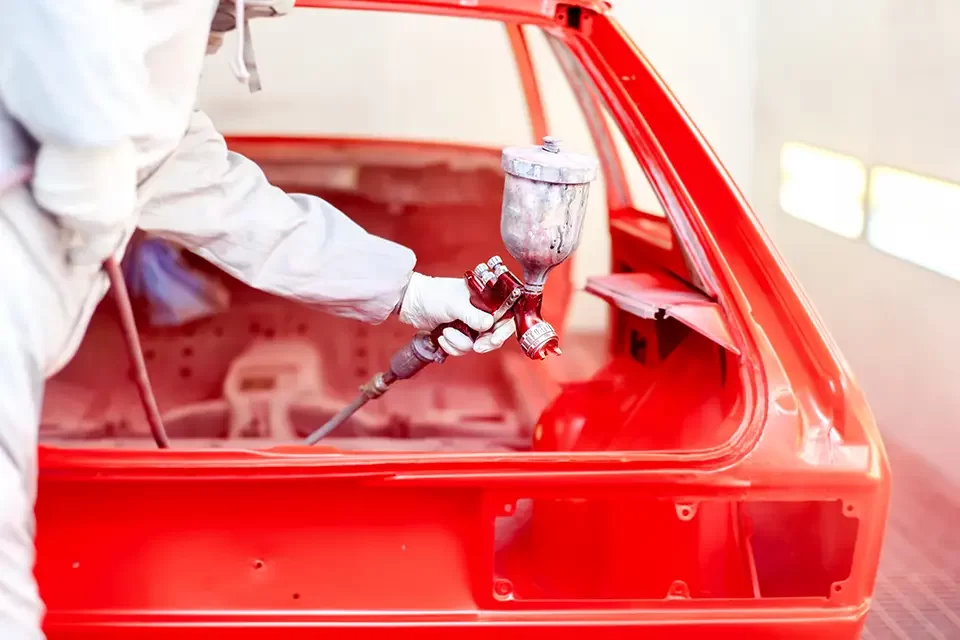 close-up-of-spray-paint-gun-with-worker-working Why Choosing the Right Car Paint Shop Matters