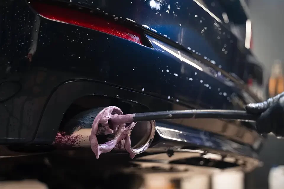 detailing-worker-cleans-exhaust-pipe-of-car-clean What to Look for in a Custom Muffler Shop Near You