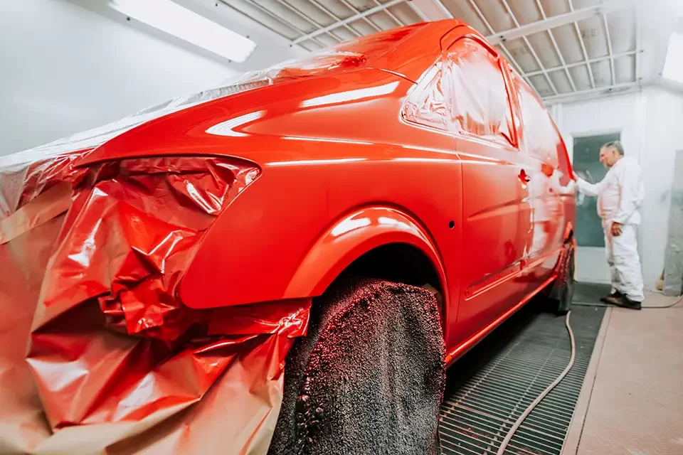 details-of-worker-inspecting-new-paint-in-car-paint Steps to Repairing Bumper Scratches