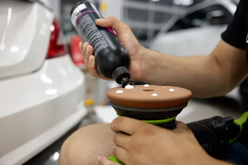 man-car-service-worker-applying-wax-cream-on-disk Car Polishing Price