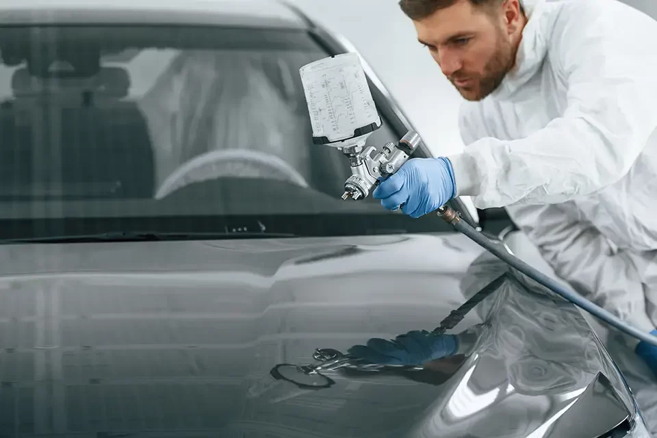 man-is-painting-a-car-by-using-spray-guy The Car Painting Process at Auto Stars Collision & Mechanic