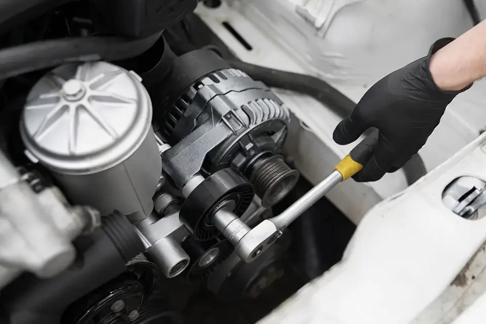 mechanic-carefully-installs-a-new-pulley Car Alternator Repair Shop