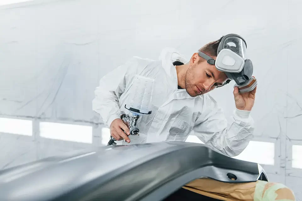 painting-the-car-man-in-uniform-is-working Benefits of Choosing Automotive Airbrush Paint