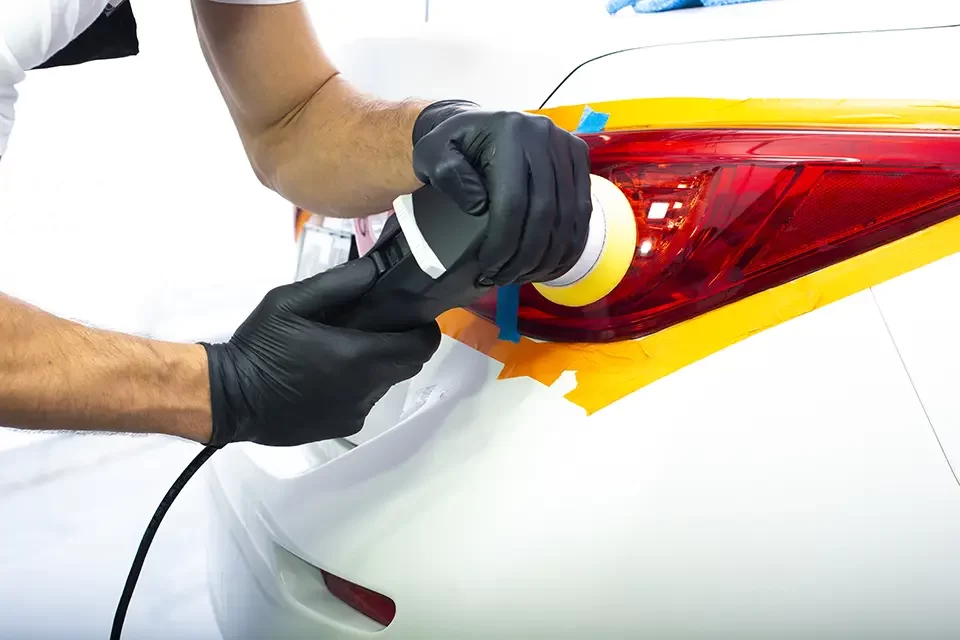 the-man-is-polishing-red-back-lights-of-a-modern The Process of Exterior Car Paint at Auto Stars Collision & Mechanic